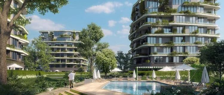 صورة خارجية لعمارتين وحمام سباحة في كمبوند ارمونيا بالعاصمة الإدارية الجديدة.