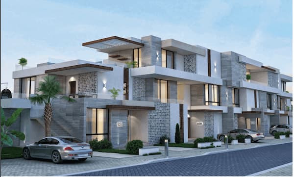 سيارات بجوار وحدات سكنية داخل قرية زويا